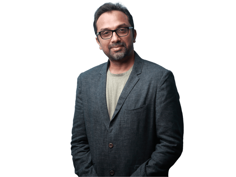 Marathi proofreading services, Portrait of a smiling man of Indian origin wearing a coat